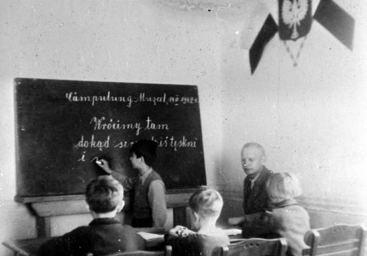 Lekcja w polskiej szkole w Campulung-Muscel. Uczeń piszący na tablicy.